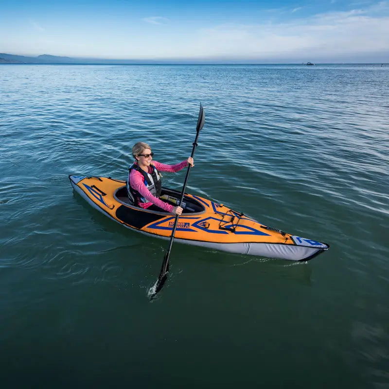 a aerial photo of a lady paddling the Sport Elite inflatable kayak from Advanced Elements
