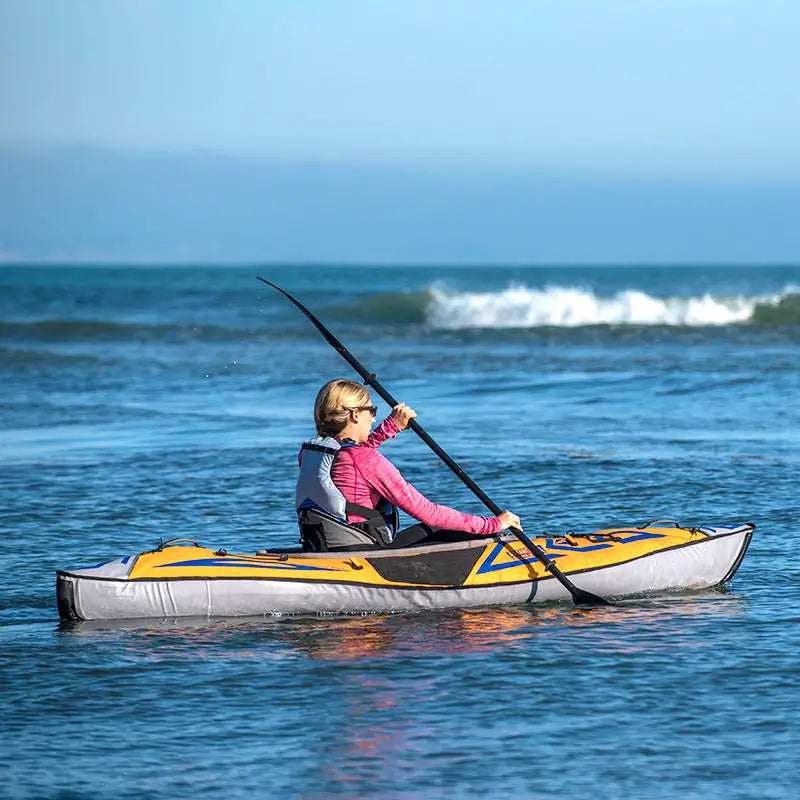 a side view of the AdvancedFrame sport elite paddling in open water 