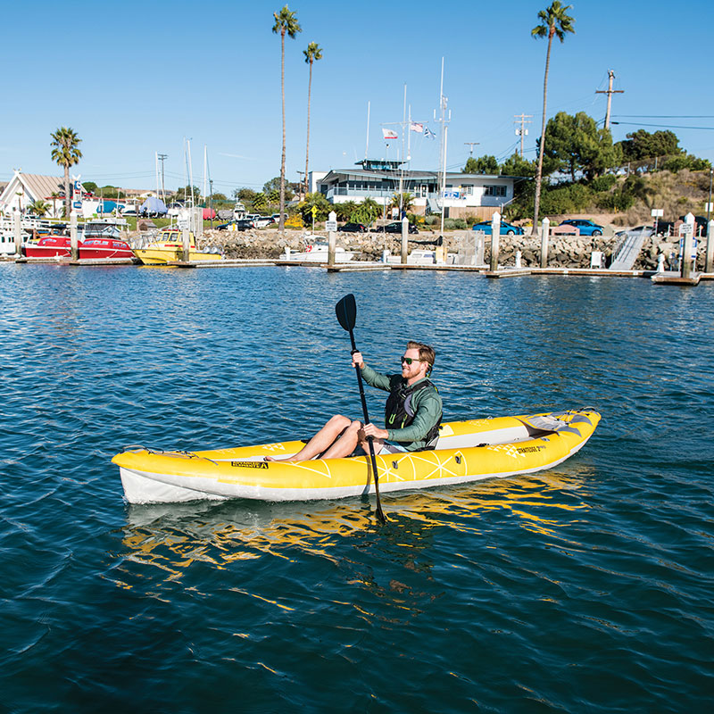 Photo of man smiling and paddling the straight edge 2 pro in a solo configuration