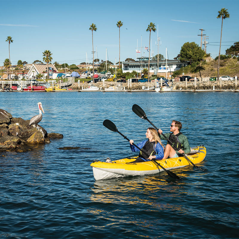 2 paddlers paddling the straight edge 2 pro in a marina