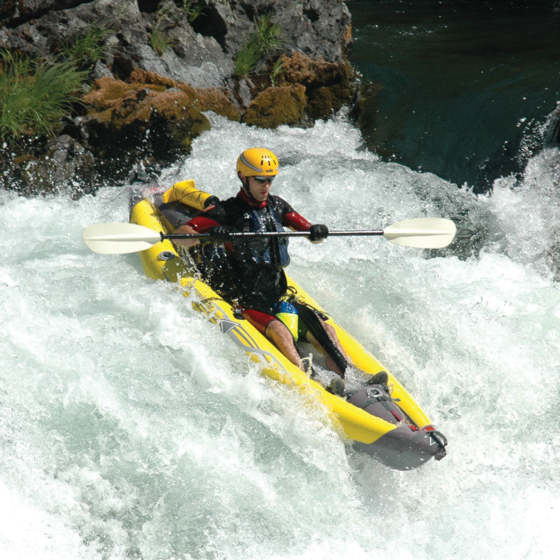 A paddler using the StraightEdge in white water rapids
