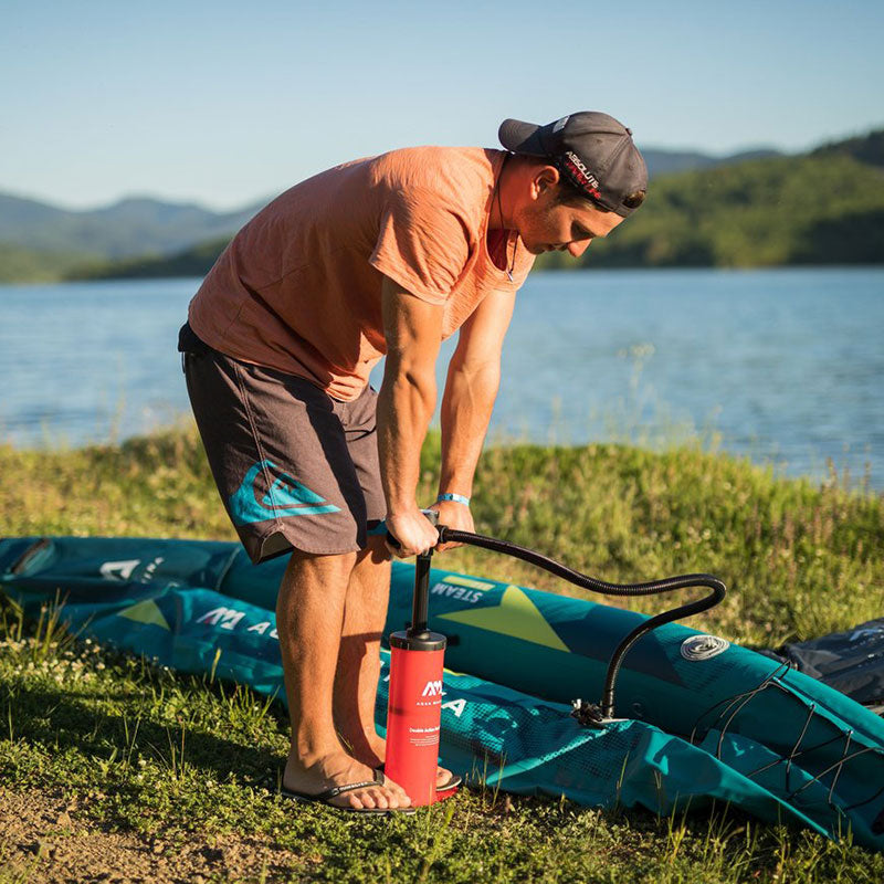 Man pumping up his inflatable kayak with the Aero II hand pump