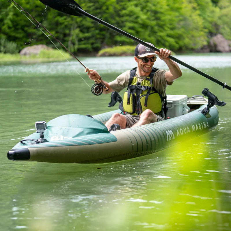 photo of man sitting in an inflatable fishing kayak