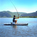 Side on photo of a man fishing on the Drift inflatable paddleboard