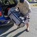 A photo of a man removing the Quest Angler from the boot of his car