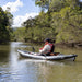 A photo from the side angle of a man fishing from the Jaspara Quest Angler Inflatable Fishing Kayak