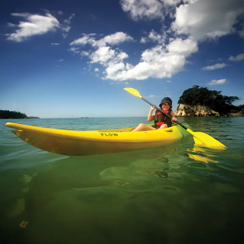 Small child learning how to paddle a kayak in the mission flow 