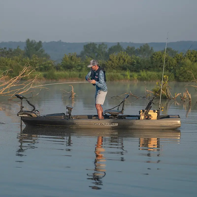 image of a man standing up while reeling in a fish in the titan x propel 125