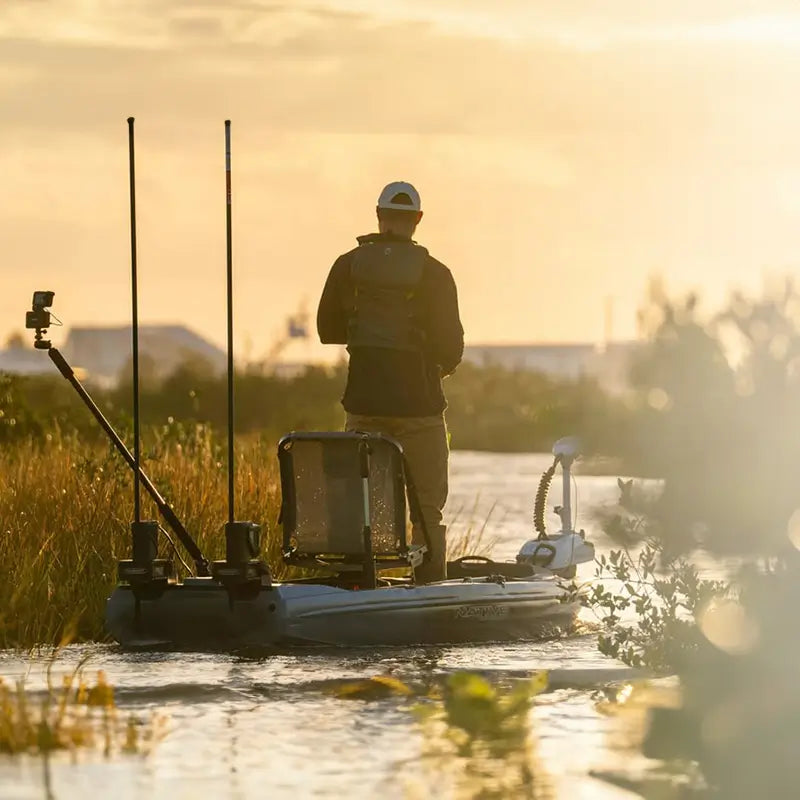 a man standing while casting in the titan x propel kayak