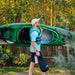 A picture of a man carrying the argo 100X kayak on his shoulders