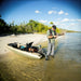 A photo of a man on the beach with his motor retracted on his Catch 100 PWR  