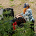 a lady getting taking stuff out of her exocrate kayak fishing crate bag